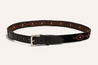 A Texas Exes II belt by Zilker Belts featuring a black Argentine suede leather strap with a metallic buckle and decorative orange and beige geometric patterns.