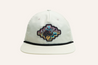 A white Zilker Sessions Rope Hat by Zilker Belts with an embroidered patch on the front featuring a multicolored design and the text "Blazer 91," reminiscent of the Zilker Sessions hat. The cap has a black trim at the edge of the bill.