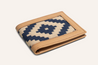 The Bogey Wallet by Zilker Belts is a handcrafted leather wallet showcasing a decorative blue and beige geometric pattern on the front.