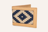 The Bogey Wallet by Zilker Belts is a tan-colored handcrafted leather wallet, adorned with an intricate blue and white geometrical pattern on the front.