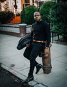 A black man leaning on a fire hydrant wearing Zilker Belts' Antone's.