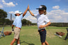 Two boys giving each other high fives while wearing Willie Kids from Zilker Belts.