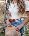 A woman holding an ATX Light hat by Zilker Belts.