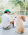 a man sitting on a bench with a Zilker Belts ATX Dog Collar