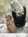 a woman sitting on steps with a Waterloo dog.