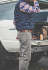 a man standing in the trunk of a white Zilker Belts Willie.