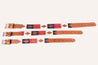 A pair of Zilker Belts Willie Dog Collar with a red, blue and white pattern.